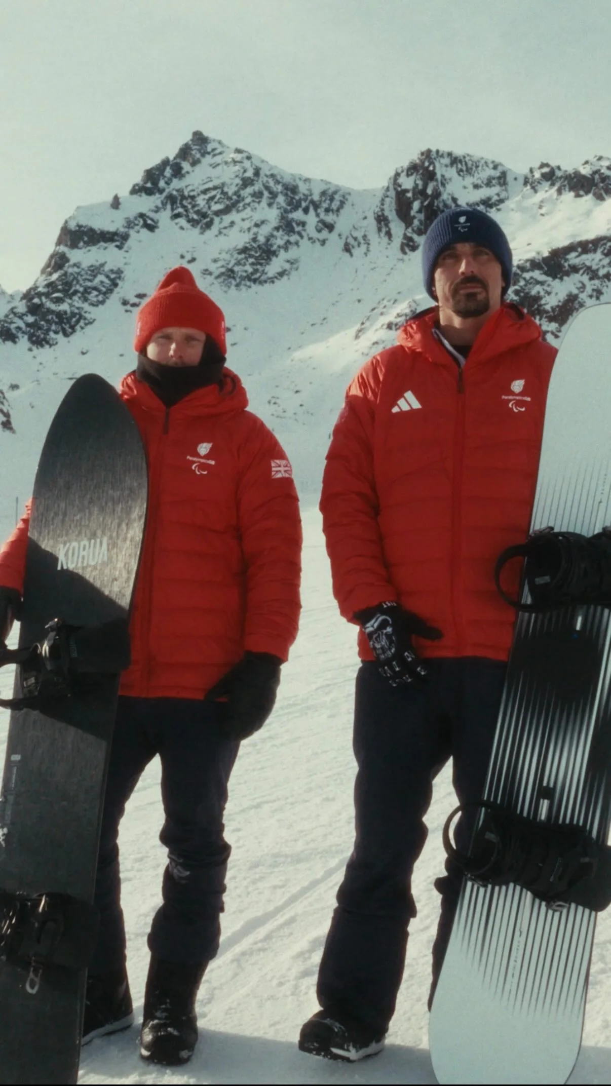 ParalympicsGB snowboarders, James Barnes-Miller and Ollie Hill, help each other get ready image